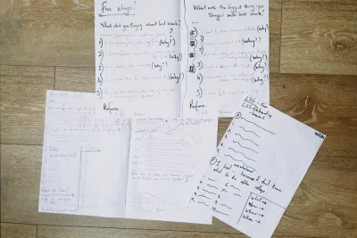 Handwritten worksheets being worked through together.